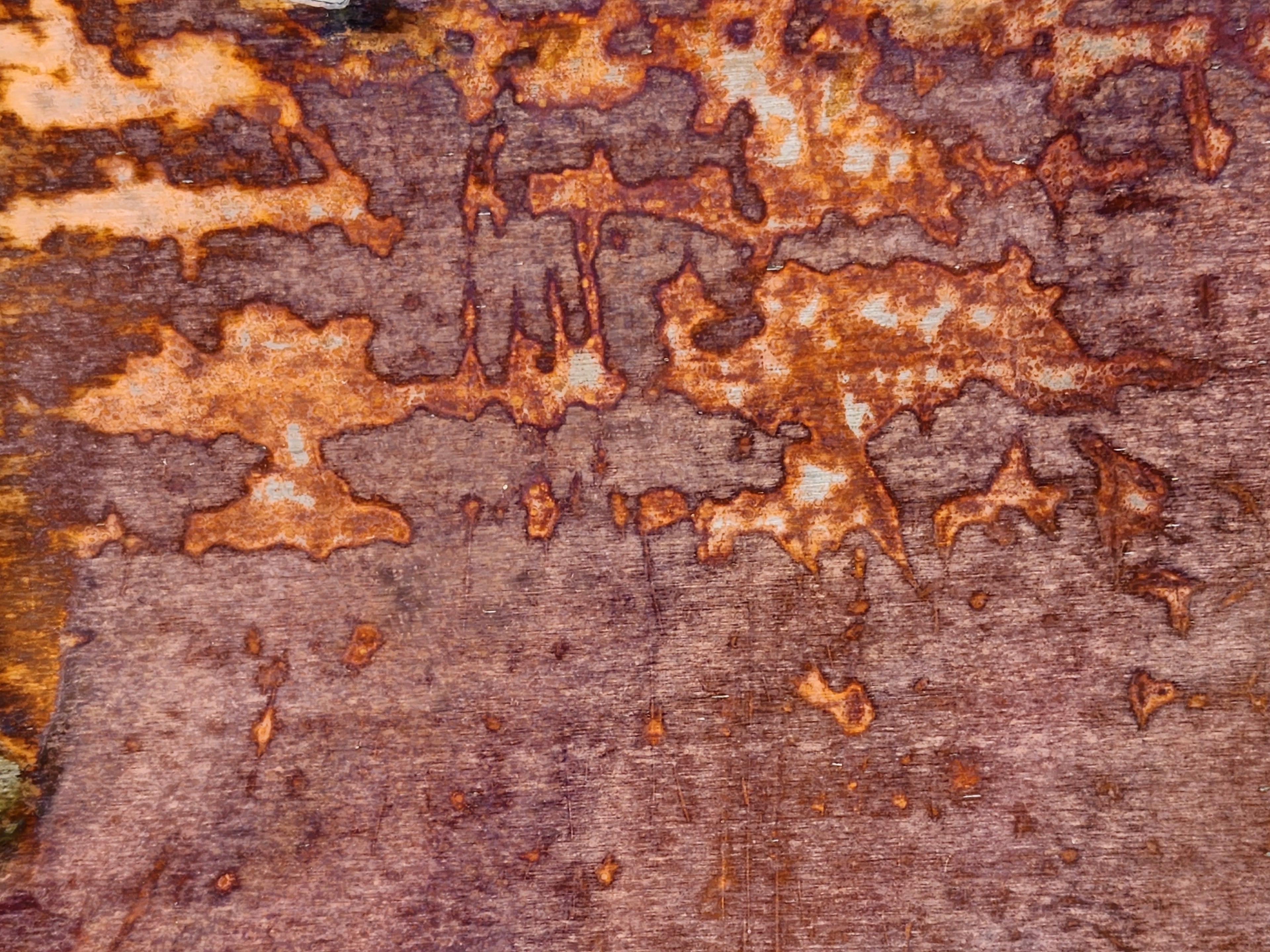 Close-up of steel metal surface with acopper patina that is brown and orange colors
